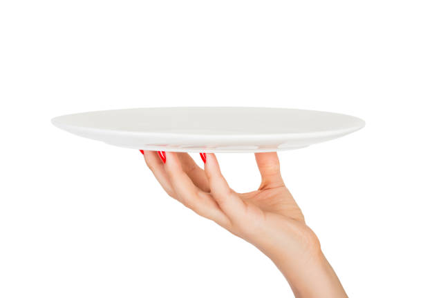 istock Blank empty round plate in female hand. perspective view, isolated on white background 1036220598