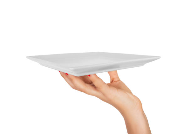 istock Blank white square matte plate in female hand. perspective view, isolated on white background 1036220608