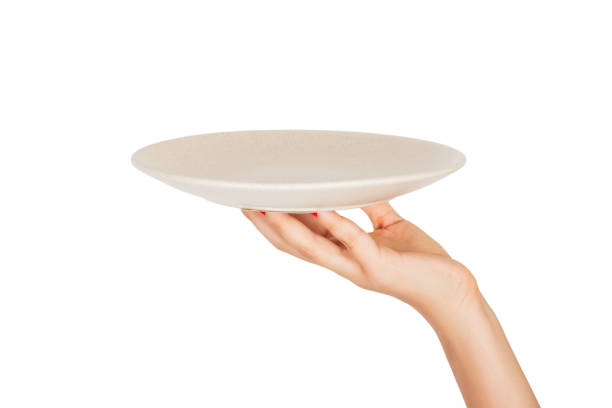 istock Blank empty round gray matte plate in female hand. perspective view, isolated on white background 1036220614