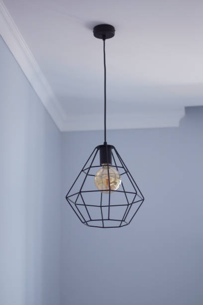 istock Black metal frame chandelier on a ceiling 1036224458