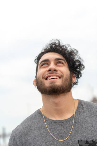 istock Young Hispanic Man Laughs and Looks Upward 1036227168