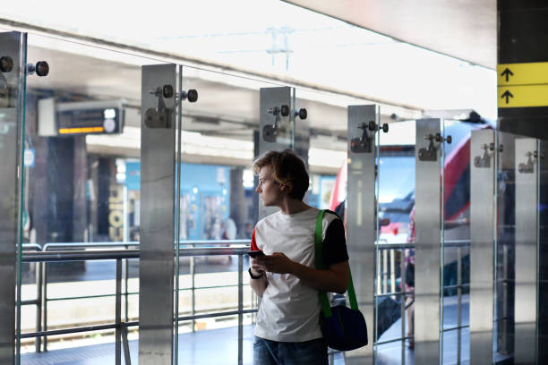istock Teenage boy using smart phone,railway station 1036230900