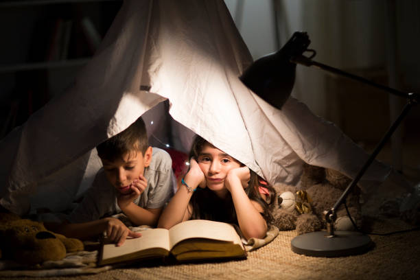 istock Kids reading in the dark 1036231316