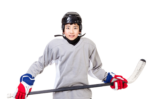 Portrait of junior ice hockey player with full equipment and sports uniform. Isolated on white background.