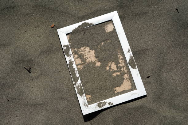 istock White Wooden Blank photo frames on beach sand 1036235150