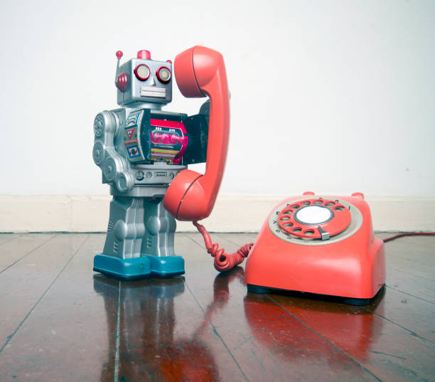 istock big silver robot toy on  a red phone standing on an old 1036235178