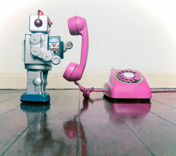 istock big silver robot toy on  a pink  phone standing 1036235196