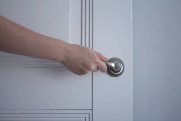 istock The woman opens a white door 1036235206