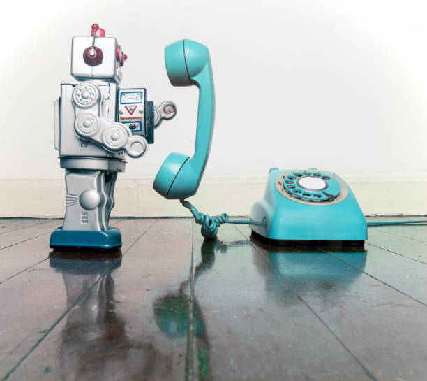 istock big silver robot toy on  a blue  phone standing 1036235216