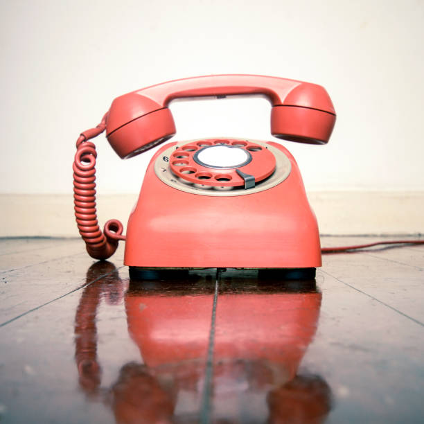 istock retro phone ringing on a old wooden floor 1036235236