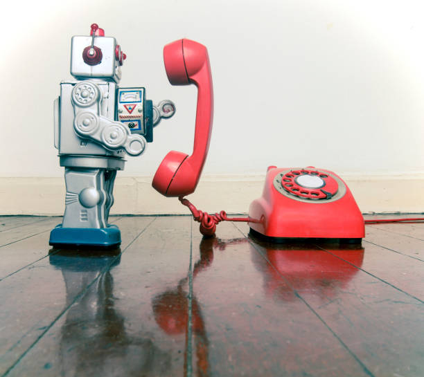 istock big silver robot toy on  a red phone standing 1036235258