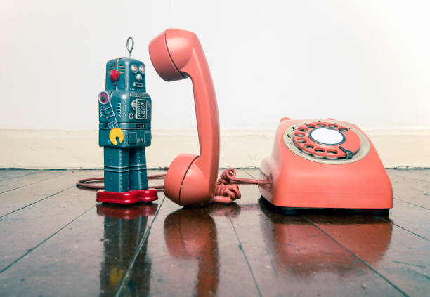 istock vintage grey robot toy on the phone standing 1036235350