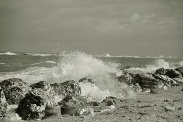 istock windy day at sea with big waves against rocks 1036240386