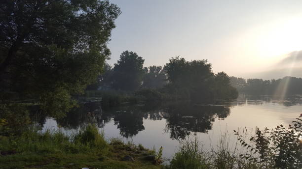 Morning at the Pond With Sun Escaping Clouds