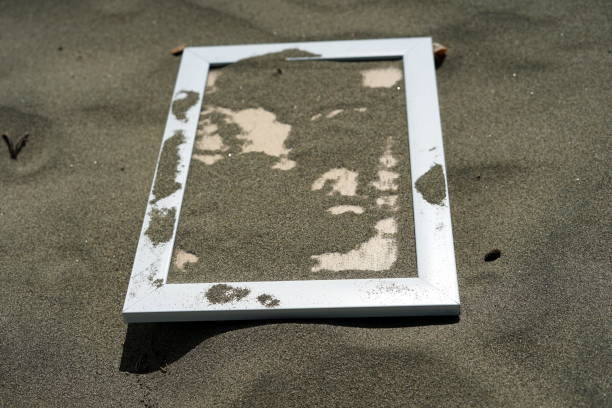 istock White Wooden Blank photo frames on beach sand 1036243958