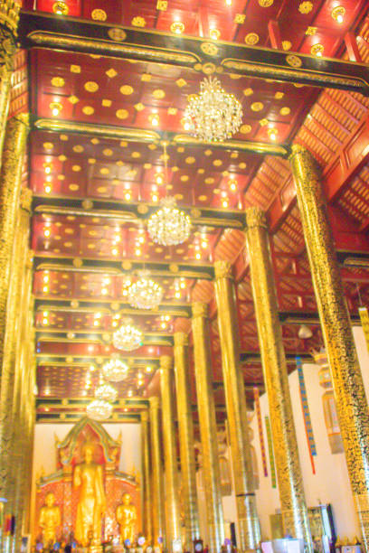 istock Beautiful large standing golden Buddha image with ceiling interior decoration, named Phra Chao Attarot at Wat Chedi Luang (temple of the big royal stupa), located in Chiang Mai, Thailand. 1036244352