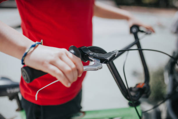 istock Midsection Of Boy Holding Bicycle Handlebar 1036253424