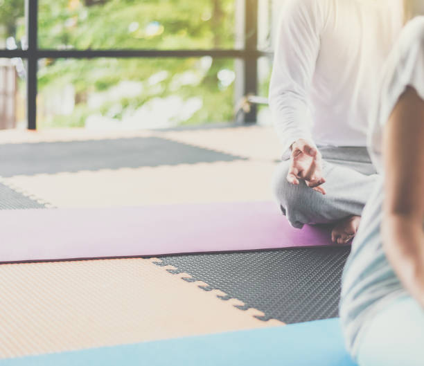 istock Low Section Of Person Meditating While Sitting In Yoga Studio 1036256560