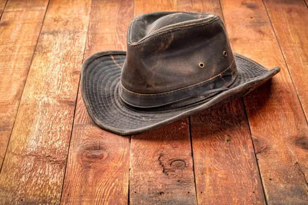 weathered outback hat on rustic red barn wood