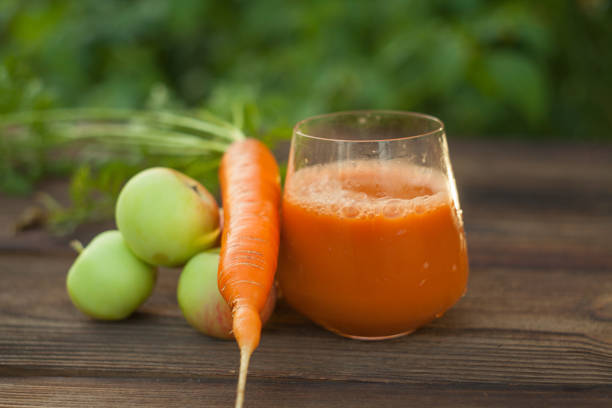 istock Carrot juice in glass on  table 1036263844