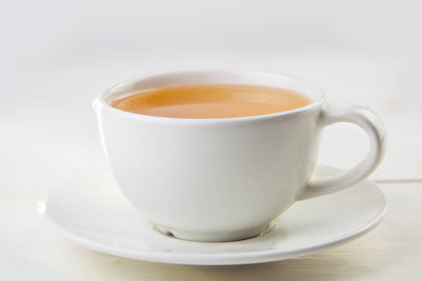 istock porcelainl cup with green tea on table 1036265088