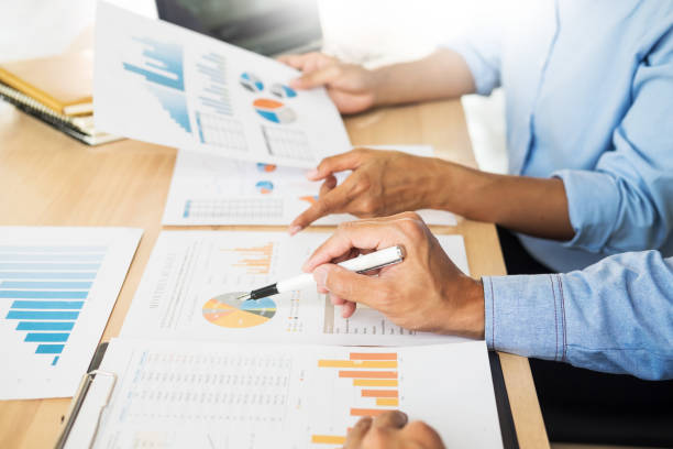 istock Midsection Of Man Analyzing Graph With Colleague At Office 1036267910