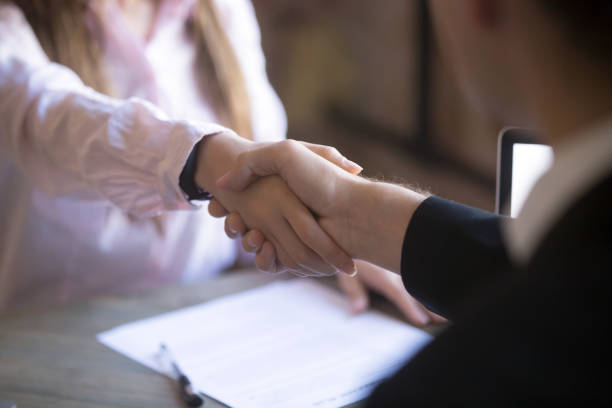 istock Handshake of man and woman 1036273884