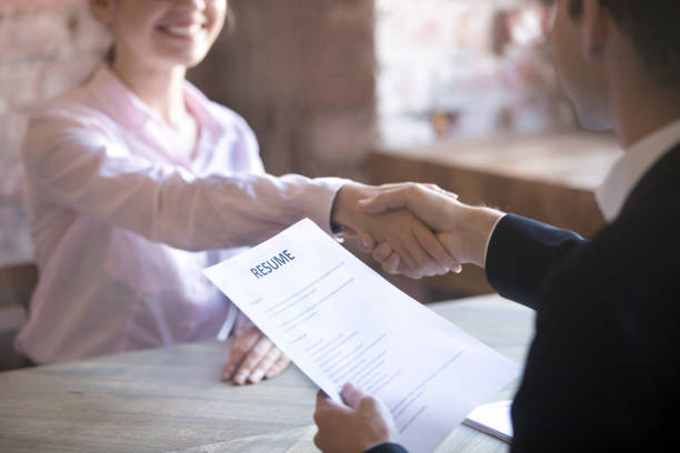 Successfully passed job interview Smiling young woman and man handshake. Businesspeople shaking hands. Human resources, successfully passing the interview, hr concept. Close up resume paper Resume stock pictures, royalty-free photos & images