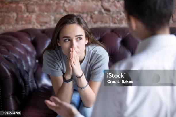 Unhappy Young Girl At The Psychologist Stock Photo - Download Image Now - Teenager, Psychotherapy, Mental Health Professional