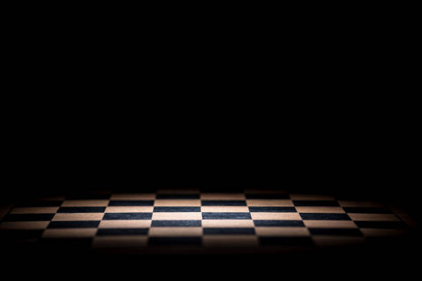 istock Close-Up Of Chess Board Against Black Background 1036290508