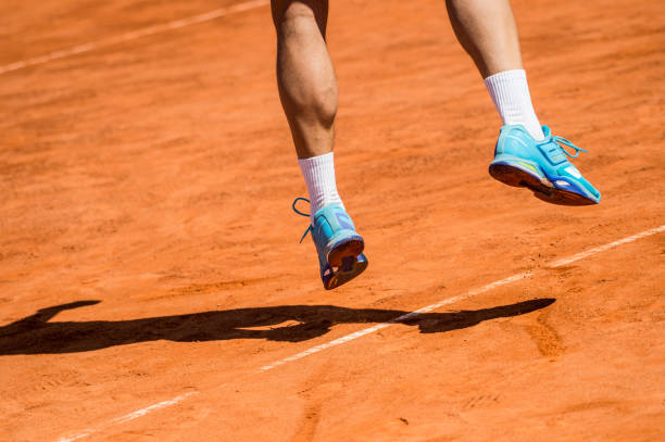 istock Low Section Of Athlete Jumping On Field During Sunny Day 1036291814