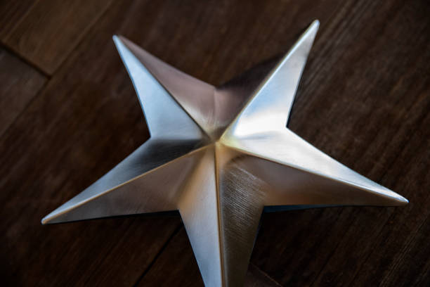 istock Silver shaped star on old retro wood background 1036292398