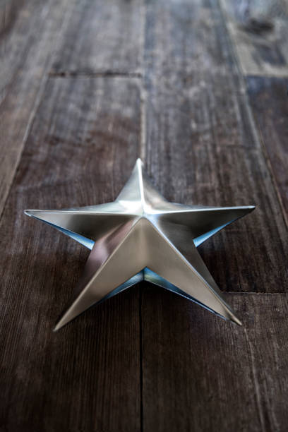 istock Silver shaped star on old retro wood background 1036292402