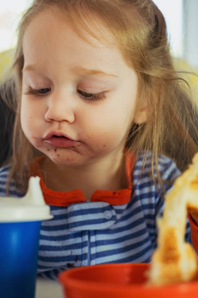 istock Girl Eating Breakfast 1036296802
