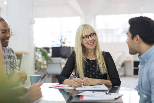 istock Middle-aged female leading a business strategy meeting 1036302246