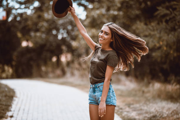 istock Cute Teen Taking Off Hat While Walking 1036309098