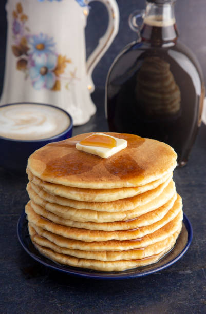 istock Stack of Freshly Made American Style Pancakes with Metling Butter 1036312316