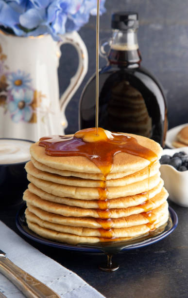 istock Stack of Freshly Made American Style Pancakes with Metling Butter 1036312694