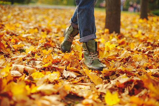 Leather shoes walking on fall leaves Outdoor with Autumn season nature on background Lifestyle Fashion trendy style