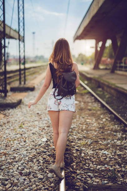 istock Woman walking on train tracks 1036322418