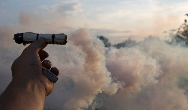 istock Smoke swirl, emits smoke in the man's hand 1036331698