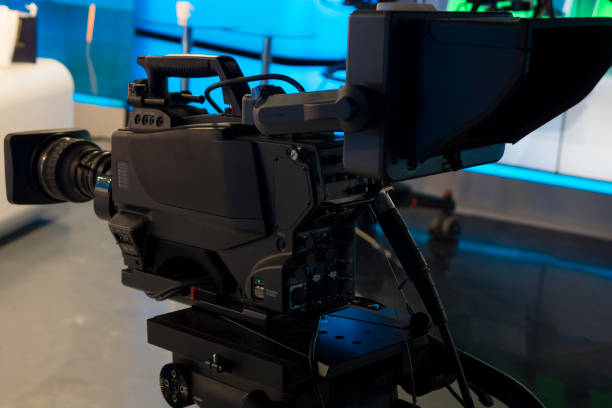 istock Video camera - recording show in TV studio - focus on camera 1036336650