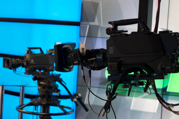 istock Broadcast television studio camera and crane camera in news studio room with LED lights 1036336660