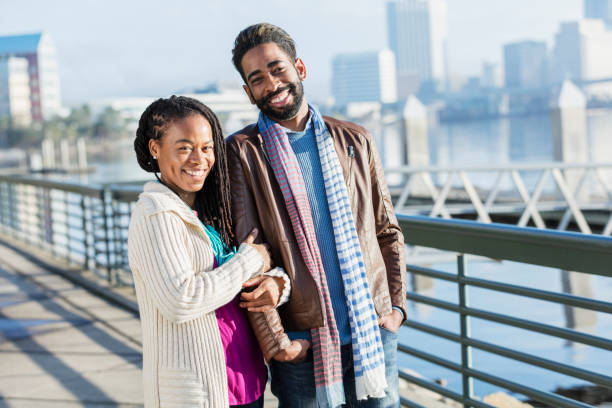 istock Mixed race couple walking together on a city waterfront 1036341162