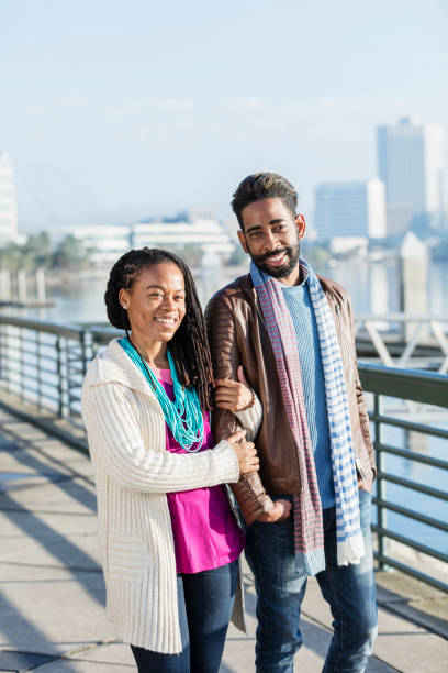 istock Mixed race couple standing together on a city waterfront 1036341532
