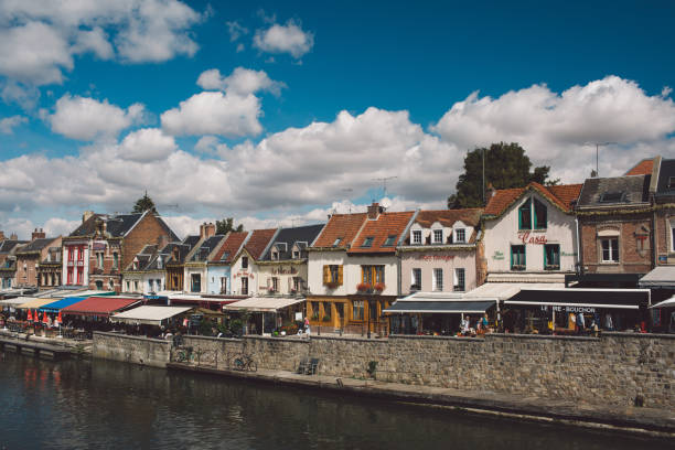 istock Houses By River In Town Against Sky 1036350788