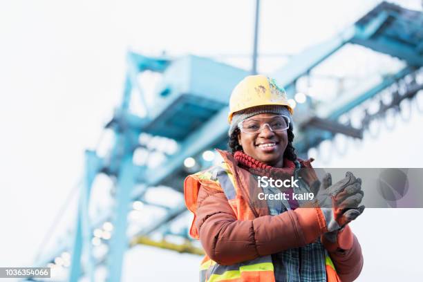Africanamerican Woman Working At Shipping Port Stock Photo - Download Image Now - Construction Worker, Engineer, Hardhat