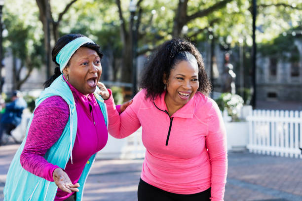 istock Two African-American women standing outdoors laughing 1036364326