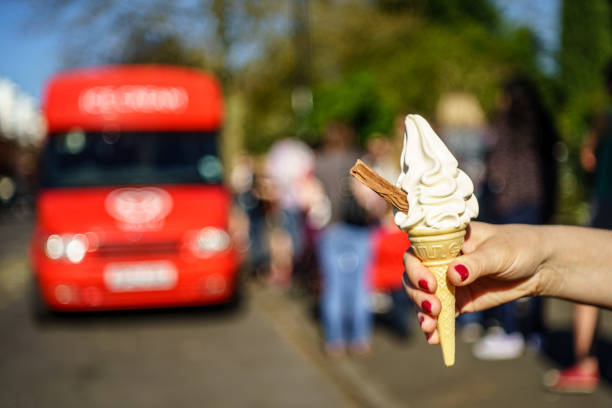 99 flek ice cream on hand in front of ice cream van 99 flek ice cream on hand in front of ice cream van ice cream van stock pictures, royalty-free photos & images