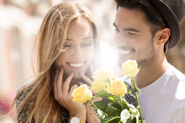istock Beautiful couple with flowers dating. 1036366512